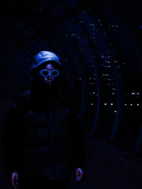 a person standing in a tunnel at night