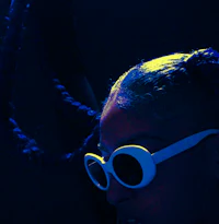 a woman with dreadlocks is holding a cell phone