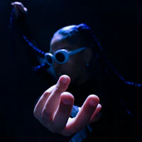 a woman with blue hair is holding up a finger