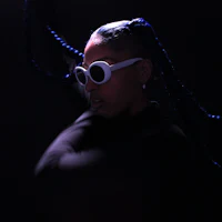 a woman in a black shirt with blue braids