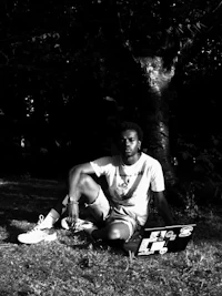 a man sitting on the ground with a laptop