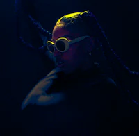 a woman with dreadlocks in the dark
